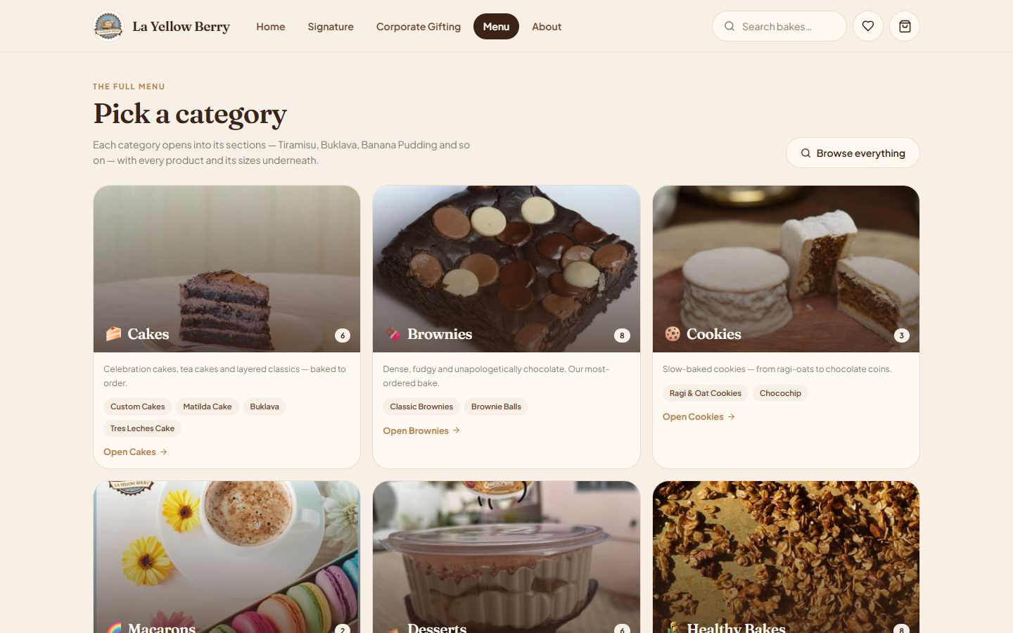 La Yellow Berry bakery menu catalogue built by Yukti AI inside its Shopify store — 'Pick a category' screen with Cakes, Brownies and Cookies cards, item counts and sub-category chips